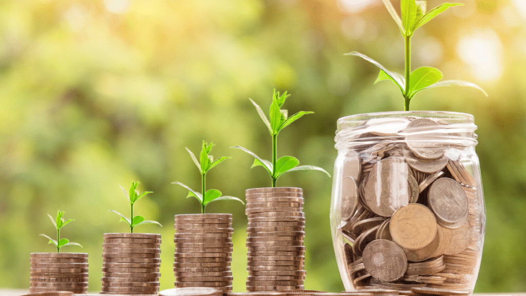 Stacks of coins growing into plants beside a jar filled with coins, symbolizing how Profit for Good amplifies global donation impact through business.